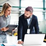 A Portrait Of An Industrial Man And Woman Engineer With Laptop In A Factory Working